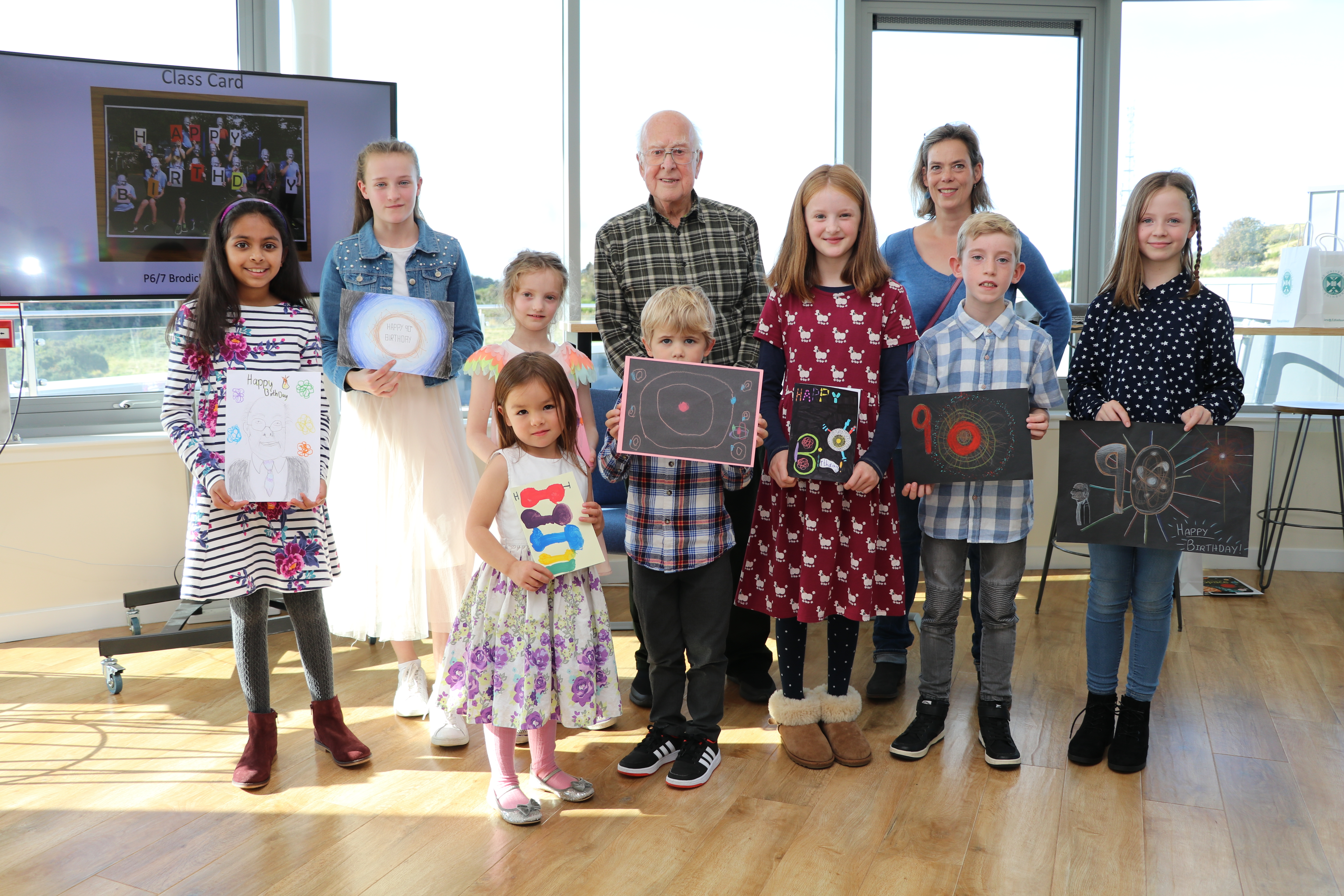 Photograph of Peter Higgs with schoolchildren at a prizegiving event at the Royal Observatory, Edinburgh on 28 Sept 2019